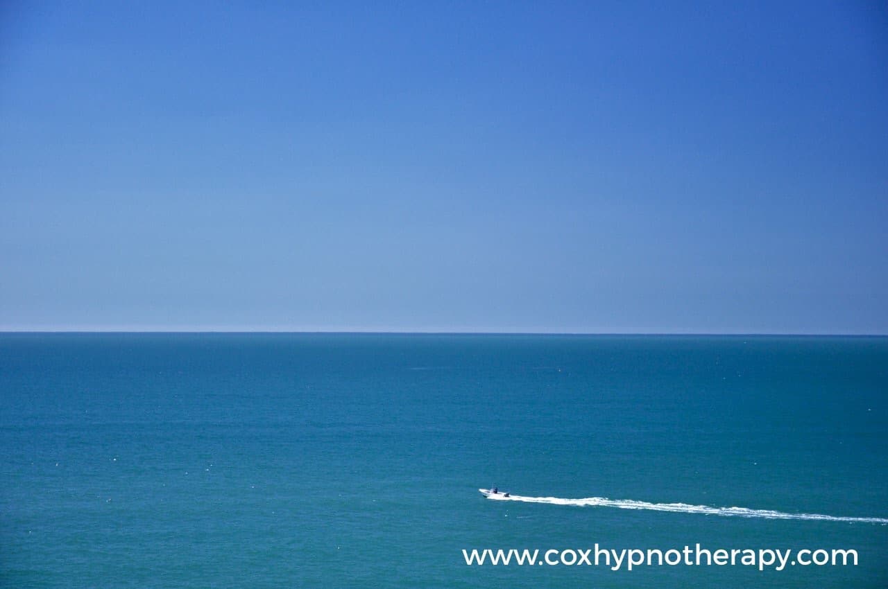 Distress to destress image of boat on water Neil Cox Hypnotherapy Cornwall