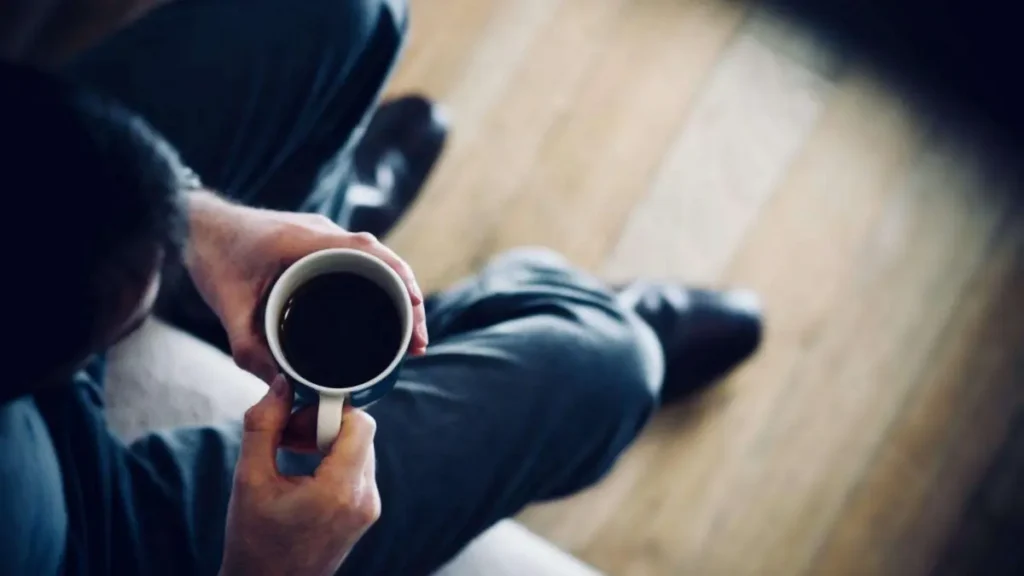 Overhead image of person with cup of tea 